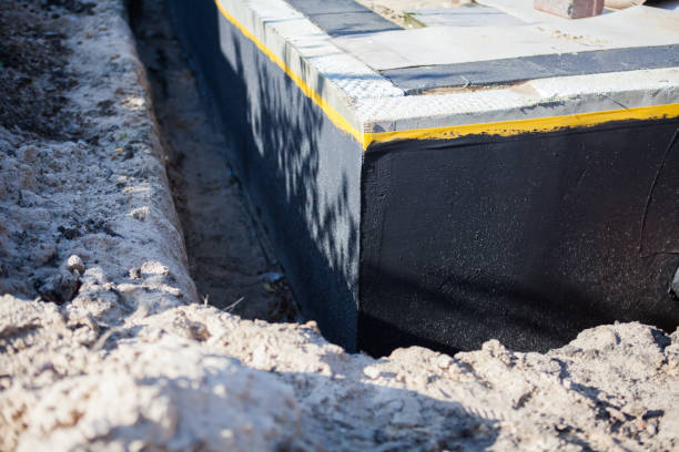 Professional Basement Waterproofing technician working in Brookville, IN